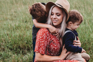 Fotoet viser en mor med børn, Siden handler om "Børnene holder traumatiserede kvinder i gang". Fotoet er taget af Jessica Rockowitz.
